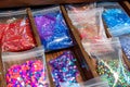 ziplock bags of sequins and beads in drawer