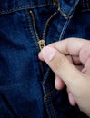 zipper from blue jeans hold hand. Royalty Free Stock Photo