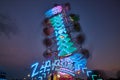 Zipper carnival ride with blurred lights during dusk at county fair Royalty Free Stock Photo