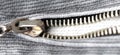 Zipper on gray denim close-up, wide view. Flat lay, top view, copy space Royalty Free Stock Photo