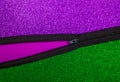 Half open zipper. Purple and green glitter background. Text space. Top View. Abstract, message, meaning, significance, life, Royalty Free Stock Photo