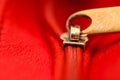 Zipper partly open binding together two layers of red fabric textile and red leather under high magnification Royalty Free Stock Photo