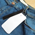 Zipper pocket and buttons blue jeans denim and blank sale tag paper Royalty Free Stock Photo