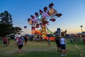 Fairground `Zipper` ride, lit up at sunset