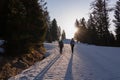 Zirbitzkogel - Two people with backpacks on snow covered hiking trail at early morning during sunrise on the way to Zirbitzkogel Royalty Free Stock Photo