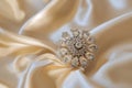 zircon brooch on creamcolored silk, elegantly spotlighted