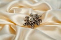 zircon brooch on creamcolored silk, elegantly spotlighted