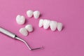 Dental tool and Zircon dentures on a pink background - Ceramic veneers - lumineers