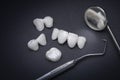 Zircon dentures and Dental tools on a dark background - Ceramic veneers - lumineers