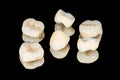 Zirconium tooth crown macro. Isolate on a black background. Aesthetic restoration of tooth loss