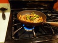 Ziti and broccoli frying on a stove top Royalty Free Stock Photo