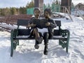 Zlatoust, Chelyabinsk region, Russia, January, 19, 2020. Sculpture `Couple reading on a bench` in the mountain Park named after P.