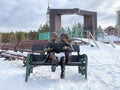 Zlatoust, Chelyabinsk region, Russia, January, 19, 2020. Sculpture `Couple reading on a bench` in the mountain Park named after P.