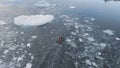 Zodiac Motor Boat in Icebergs, Tracking Aerial Top Down View. Royalty Free Stock Photo