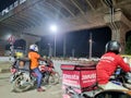 Zomato bike rider delivery boy looking at rider from swiggy food tech starup apps showing rivalry and switching between