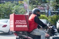 Zomato delivery boy with red hot box for food on a bike zooming at high speed to deliver orders for the upcoming Royalty Free Stock Photo