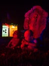 Zombie Babies Sit in Front of Tombstone