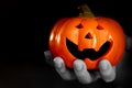 Zombie hand with helloween smile pumpkin nightmare trick or treat