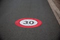 Zone 30 text paint city road car sign to limit town center vehicle speed to 30km per hour