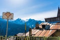 Free Wi-Fi zone sign, tin, rusted roof and snow-capped mountains in the background. Royalty Free Stock Photo