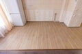 Zoning floor in interior, ceramic kitchen tiles bordered with laminate flooring in the living room