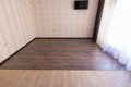 Zoning floor in interior, ceramic tile smoothly into the living room laminate