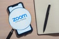 Zoom app logo on the screen smartphone close-up. Preparing for an online meeting.
