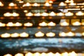 Zoom, blur illuminated candles diminishing perspective