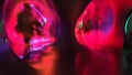 Zoom blur of an people rear view walking into a vivid colorful tunnel. Traveling through time image. Wide aspect ratio of 16:9