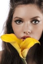 Zoom on a girls face with a yellow calla Royalty Free Stock Photo