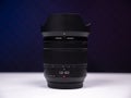 Zoom lens with a focal length of 12-60mm stands on a white table Royalty Free Stock Photo