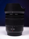Zoom lens with a focal length of 12-60mm stands on a white table Royalty Free Stock Photo