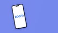 Zoom Logo on Mobile Phone Screen on Blue Background with Copy Space