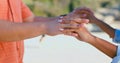 Zoom, love and couple holding hands at a beach with respect, gratitude and trust in nature together. Commitment, closeup