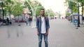 Zoom-in time lapse of African American student standing in street with backpack