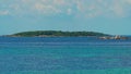 Zoom in to the other size of Island from Munnok Island Thailand, See Haft between sky and sea with green forest island in betwee