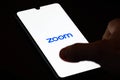 Zoom Video Communications app on the smartphone with finger Royalty Free Stock Photo