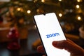 Zoom Video Communications app on the smartphone with finger Royalty Free Stock Photo