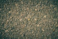 Zoom View Gravel on Asphalt Road Texture Background in Vintage Tone