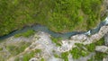 Zoomed aerial video of river, going through it's canyon, full of green vegetations