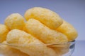 Zoomed Corn Puffs in a Glass Bowl. Crunchy Flavored Puffed Snacks. Party, Movie Snacks