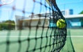 Zooming in for the action. a tennis ball hitting a tennis net on the court during the day. Royalty Free Stock Photo