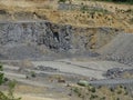 Zooming into limestone quarry with power shovel