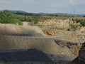 Zooming into limestone quarry with roads for trucks