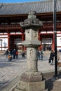 Stone lantern in front of the second antique wooden archway entrance of Todaiji temple.