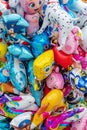 Bunch of helium balloons with various famous cartoon characters for children on street market