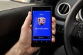 ZRENJANIN, SERBIA - APRIL 2, 2021: Male hand holding smartphone with Uber app screen in the car