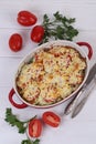 Zucchini casserole with cheese on a white wooden background