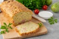 Zucchini bread with cheese, ham and fresh herbs on a wooden board on a gray background. Healthy food Royalty Free Stock Photo