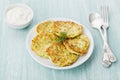Zucchini cabbage pancakes or vegetable fritters with sour cream Royalty Free Stock Photo